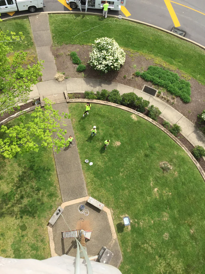 View straight down from the top of a flagpole to the ground below