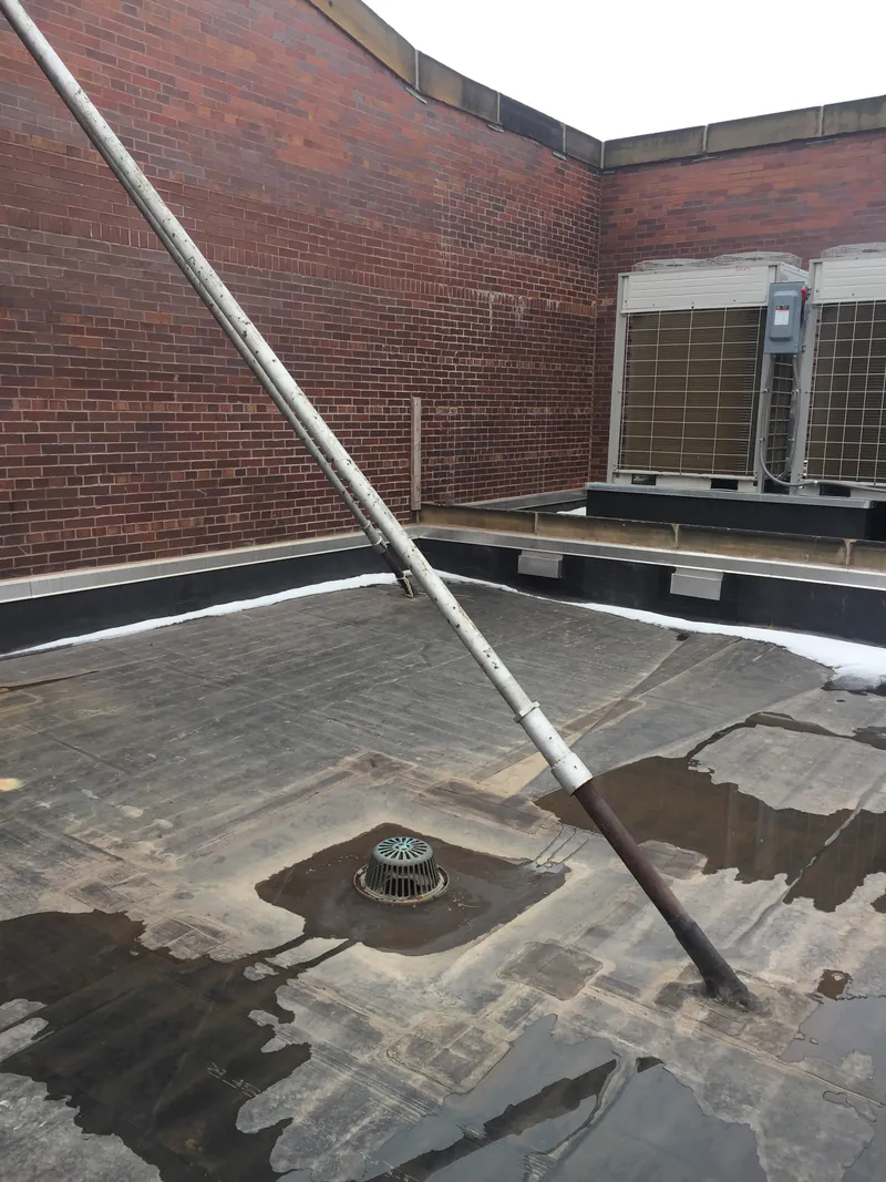 Flagpole base set on a commercial flat roof