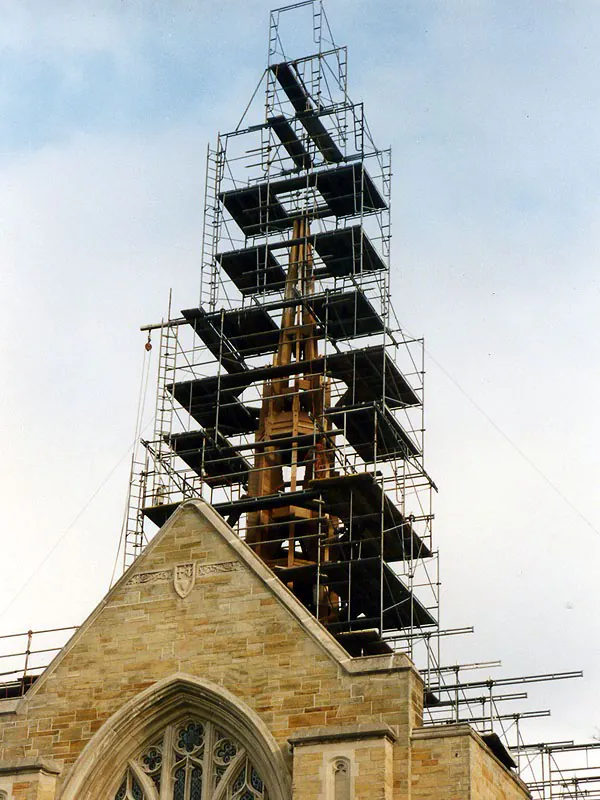 Gothic church steeple fully enclosed in scaffolding for restoration