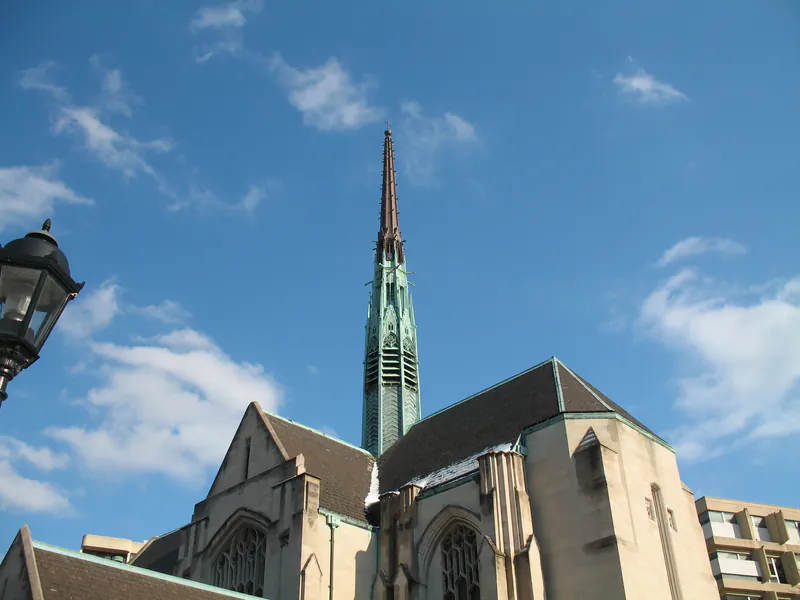 Verdigris copper Gothic spire above a stone church